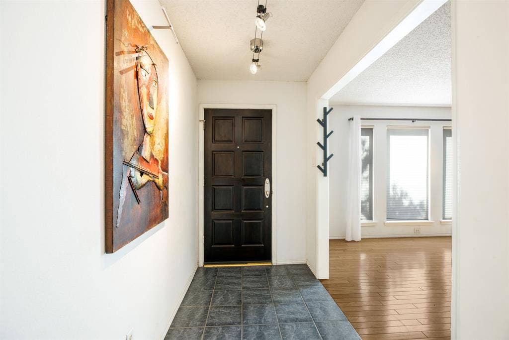 765 Eiffel Drive, Plano, TX 75023 Entryway featuring dark tile flooring and a paneled entry door