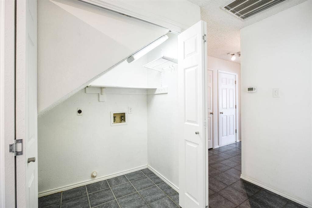 765 Eiffel Drive, Plano, TX 75023 Laundry area featuring a utility hookup, tiled flooring, and a storage shelf