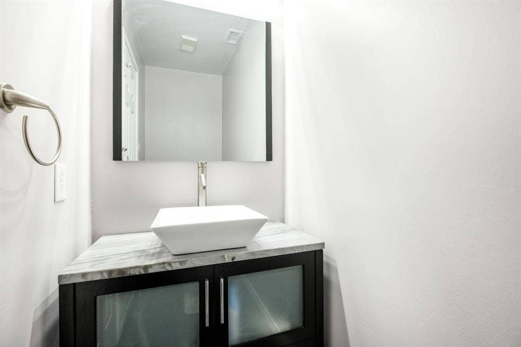 765 Eiffel Drive, Plano, TX 75023 Floating vanity with a vessel sink, single-handle faucet, and stone countertop