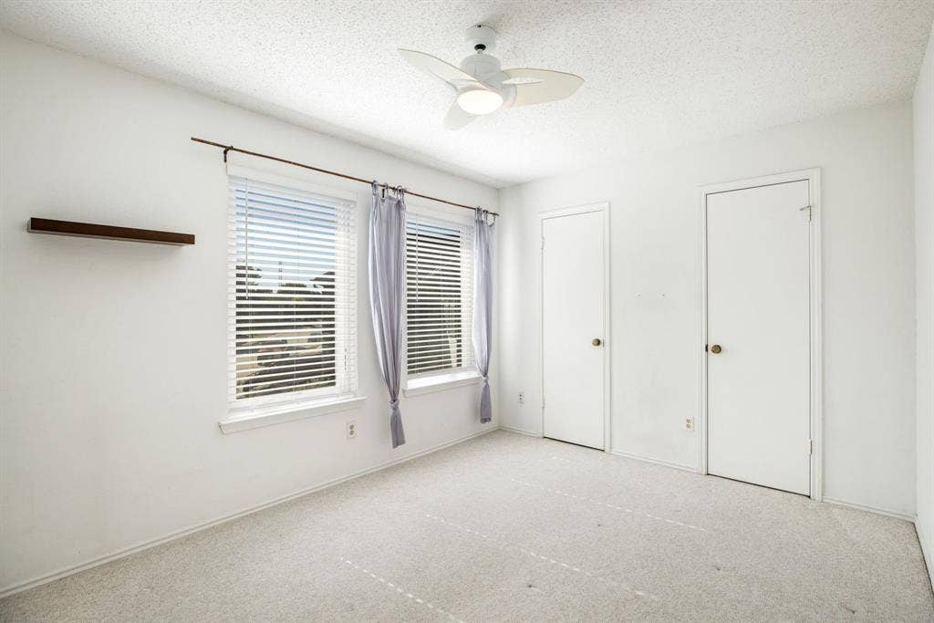 765 Eiffel Drive, Plano, TX 75023 Ceiling fan with integrated lighting, two windows with blinds, built-in floating shelf, and two interior doors