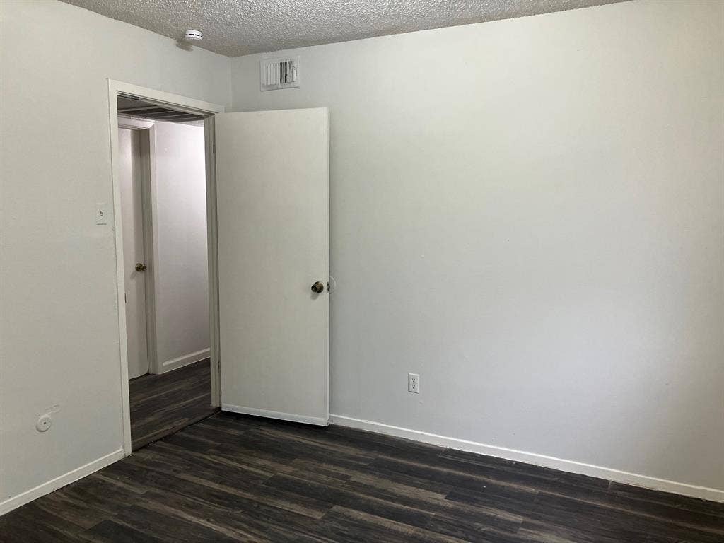 5727 Harvest Hill Road, #1042, Dallas, TX 75230 White painted walls with dark wood-finish flooring