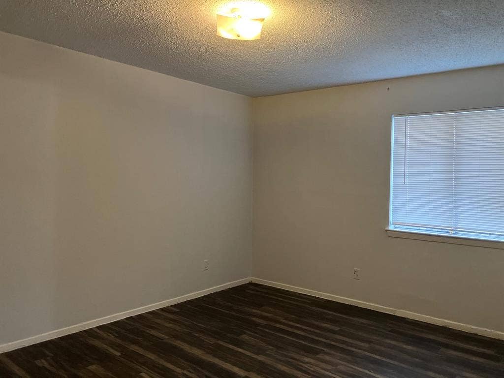 5727 Harvest Hill Road, #1042, Dallas, TX 75230 Wood-finish flooring, neutral wall tones, and overhead lighting