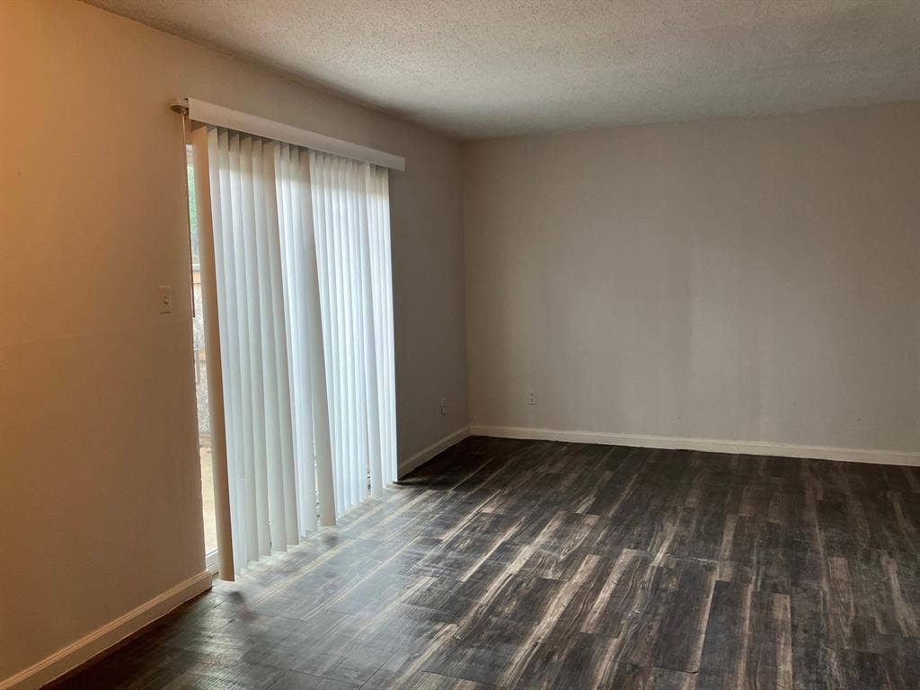 5727 Harvest Hill Road, #1042, Dallas, TX 75230 Wood-finish flooring, light neutral wall paint, and vertical blinds