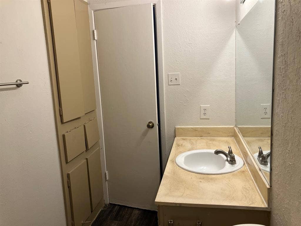 5727 Harvest Hill Road, #1042, Dallas, TX 75230 Built-in vanity with an oval sink and a metal faucet
