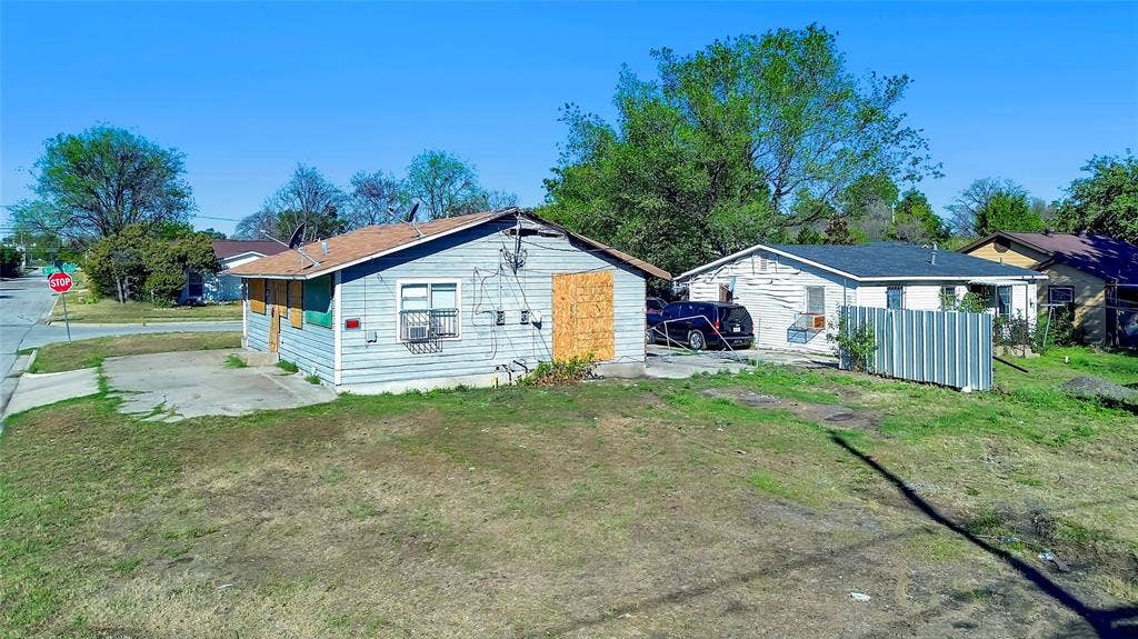 2745 S Jones Street, Fort Worth, TX 76104 Corner property with a pitched roof and a concrete driveway