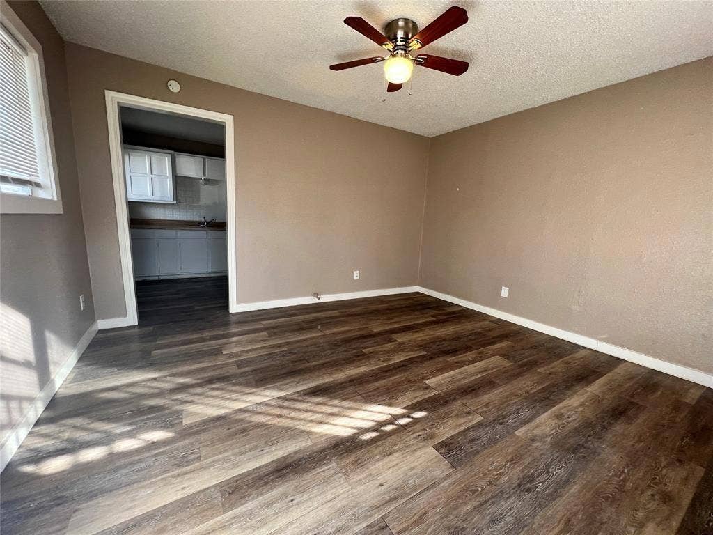 2745 S Jones Street, Fort Worth, TX 76104 Wood-finish flooring throughout, ceiling fan with integrated lighting, and neutral wall tones