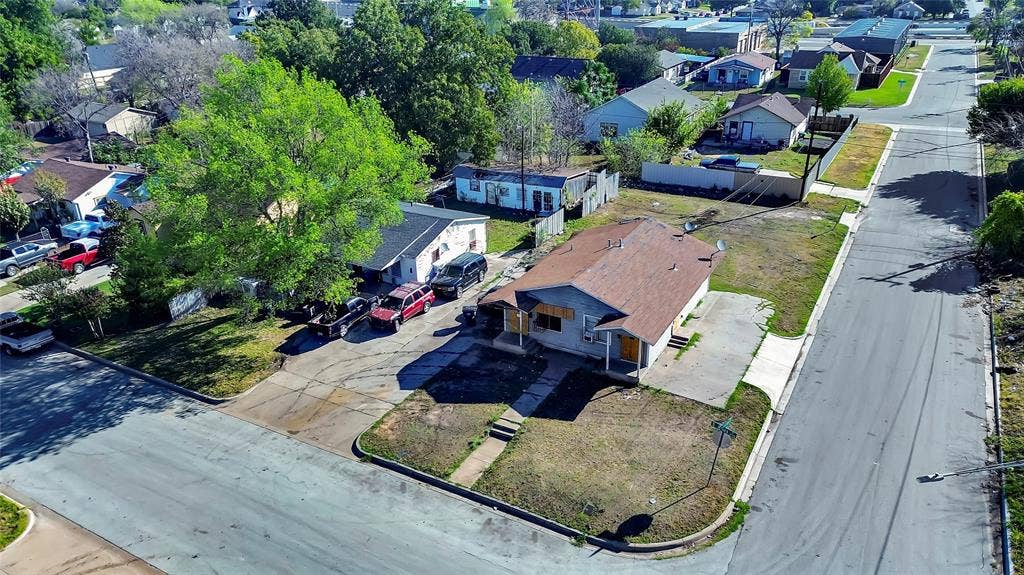 2745 S Jones Street, Fort Worth, TX 76104 Corner property with a pitched roof and a concrete driveway