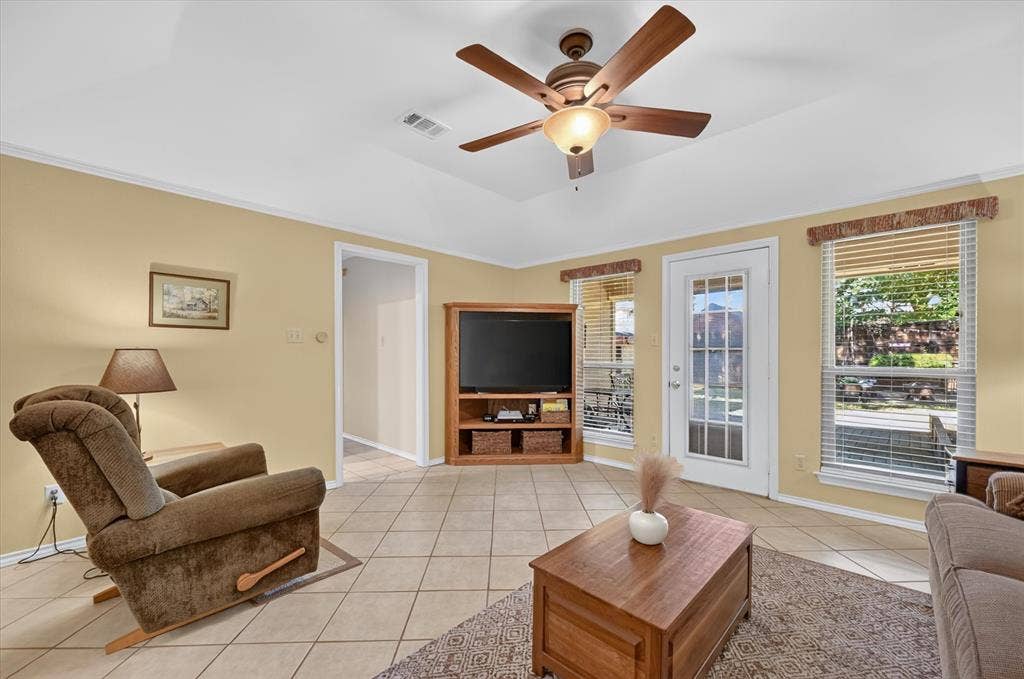 The hallway to the 2 additional downstairs bedrooms is off of the extended family room that has tile floors and a nice view of the backyard.
