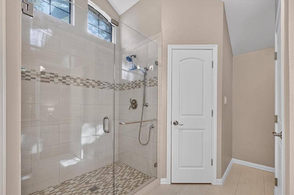 The updated primary bathroom has a large walk in shower.