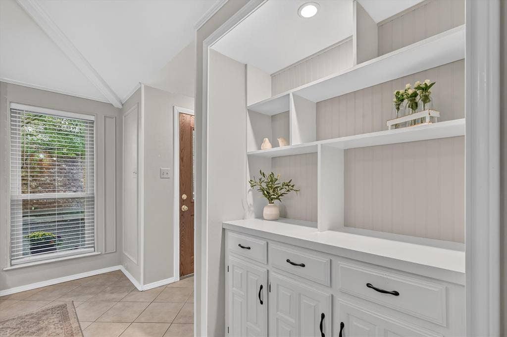 A very pretty built in cabinet with lighting off of the entry.