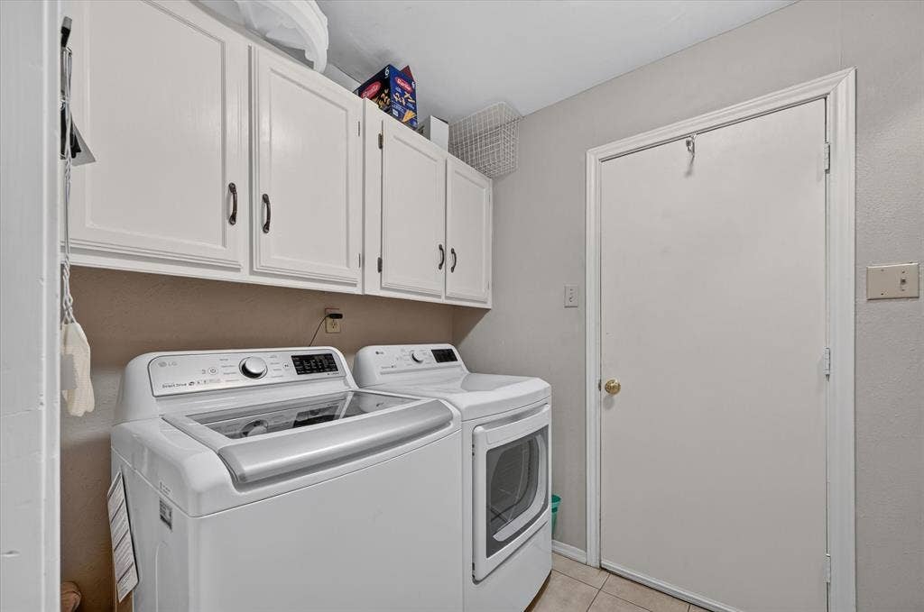 Laundry room has cabinets and is off of the garage and kitchen.