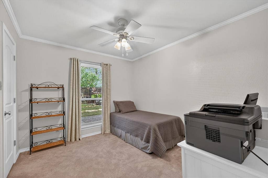 One of two secondary downstairs bedrooms that has a walk in closet & a ceiling fan and upgraded carpet.