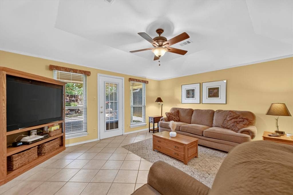 This living room offers a nice view of the park like setting in the backyard.