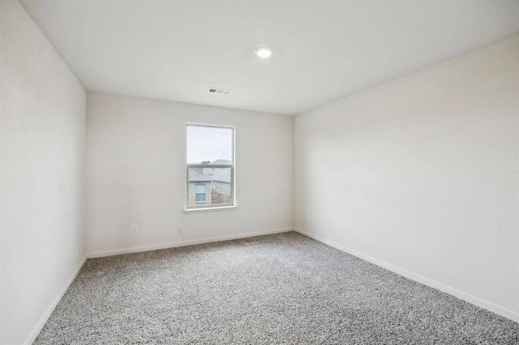 Carpeted flooring, single window, recessed lighting, and neutral wall color
