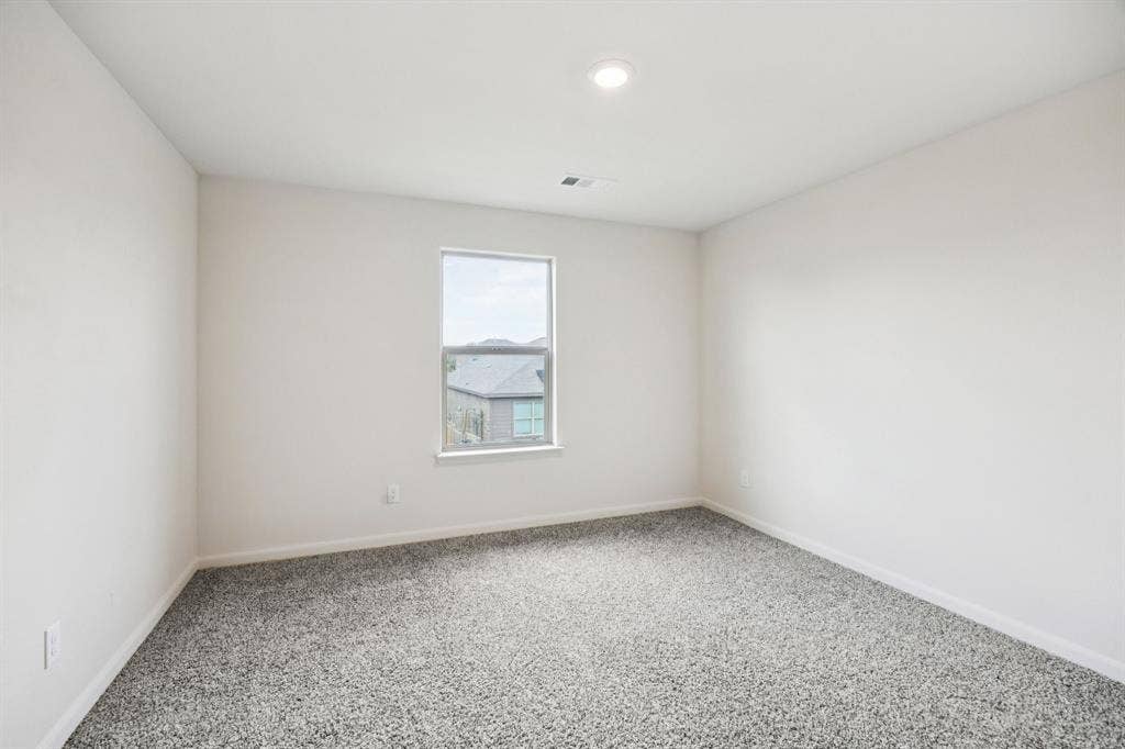 Recessed ceiling lighting, a single window, and neutral wall paint