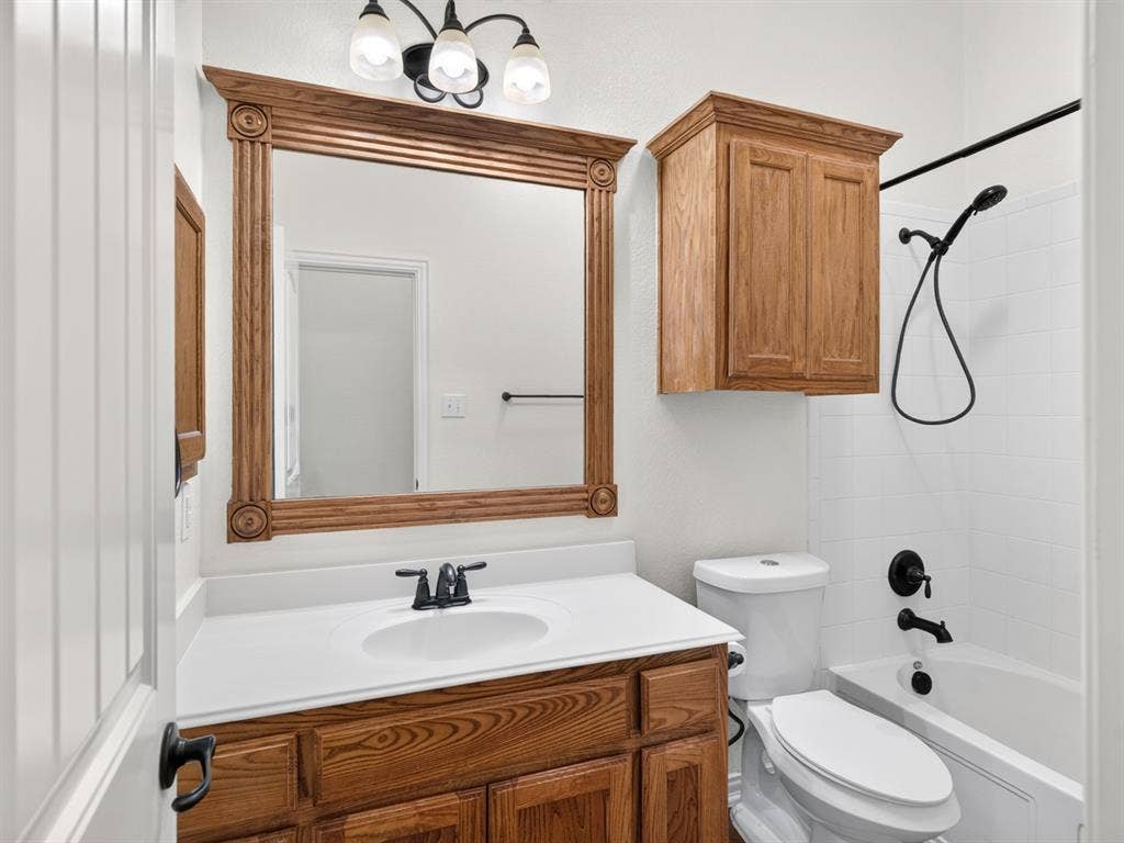 Wood-finish vanity with an integrated sink and white countertop