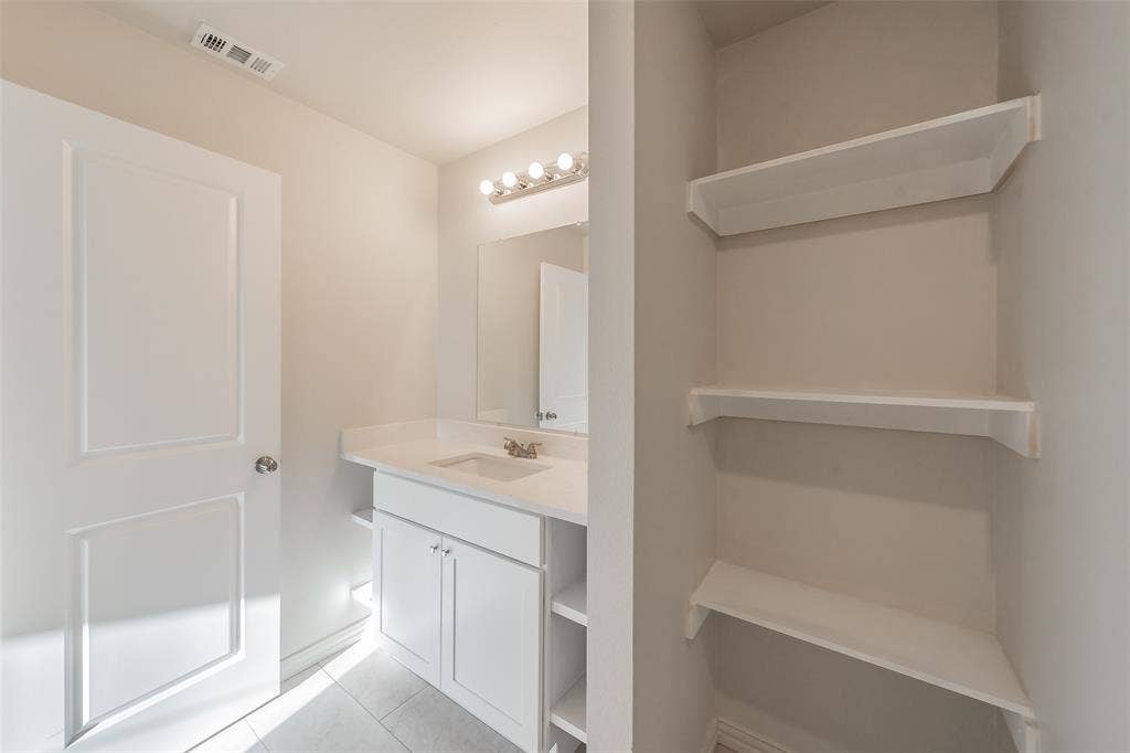 6215 Roby Drive, Arlington, TX 76001 Stylish storage through the bathroom