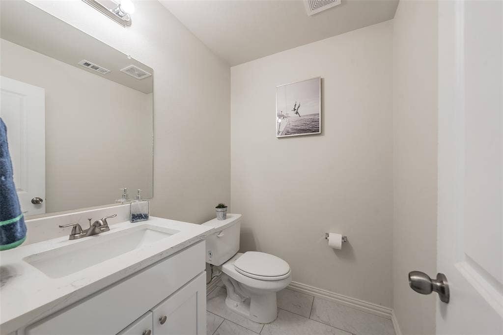6215 Roby Drive, Arlington, TX 76001 Half bathroom located downstairs next to kitchen .