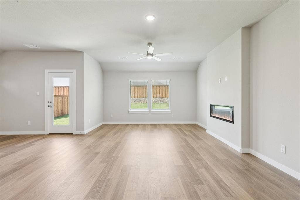 1309 Companero Street, Haslet, TX 76052 Living room in the Heisman home plan – REPRESENTATIVE PHOTO