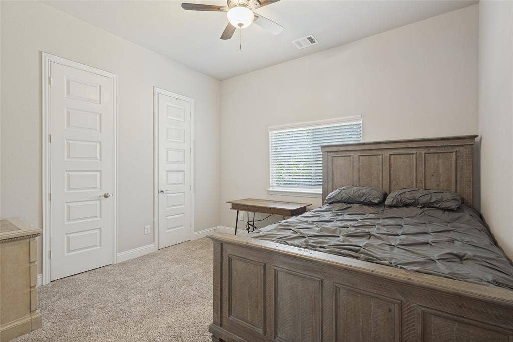 Vaulted ceiling, ceiling fan, neutral wall tones, window with blinds, and carpet flooring