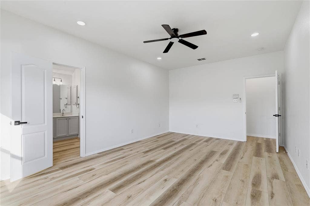 10709 Nantucket Drive, Rowlett, TX 75089 Spacious room featuring wood-finish flooring, recessed lighting, and a ceiling fan with a matte black finish