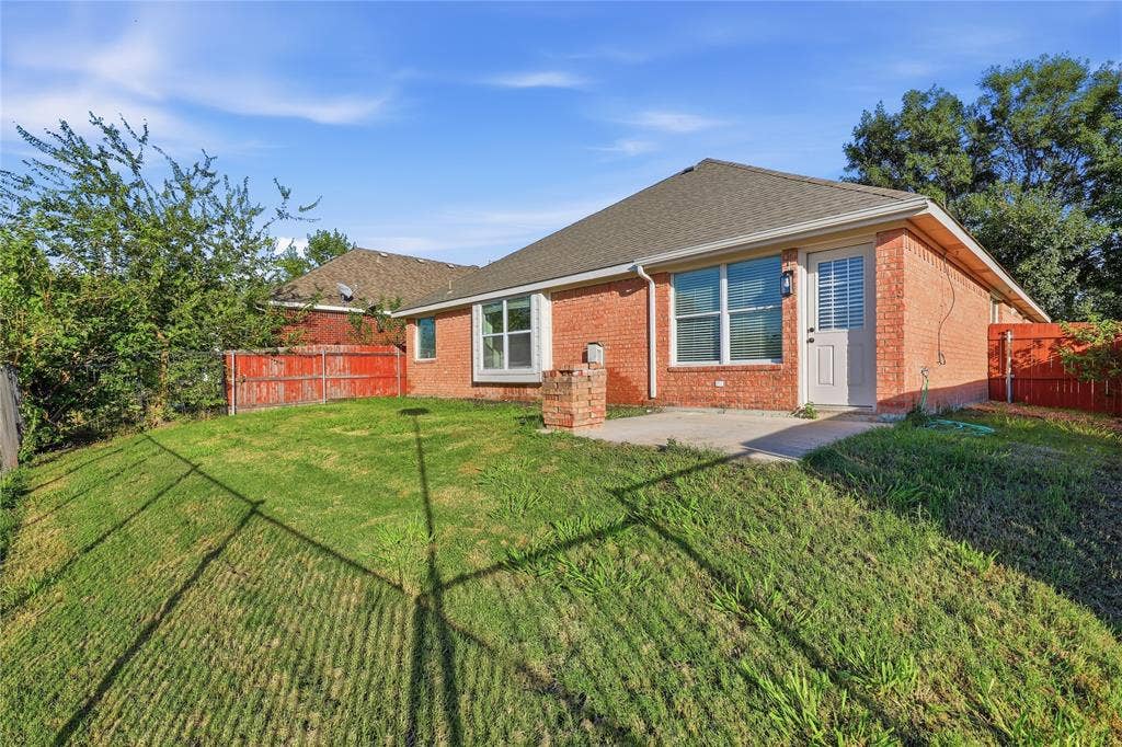 10709 Nantucket Drive, Rowlett, TX 75089 Brick exterior with a gabled roof and white trim