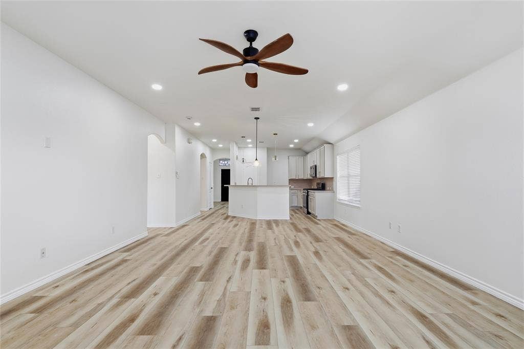 10709 Nantucket Drive, Rowlett, TX 75089 Wood-finish flooring, recessed lighting, and a ceiling fan