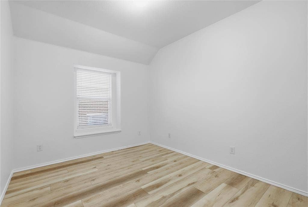 10709 Nantucket Drive, Rowlett, TX 75089 Wood-finish flooring with white trim, a single window with blinds, and white painted walls