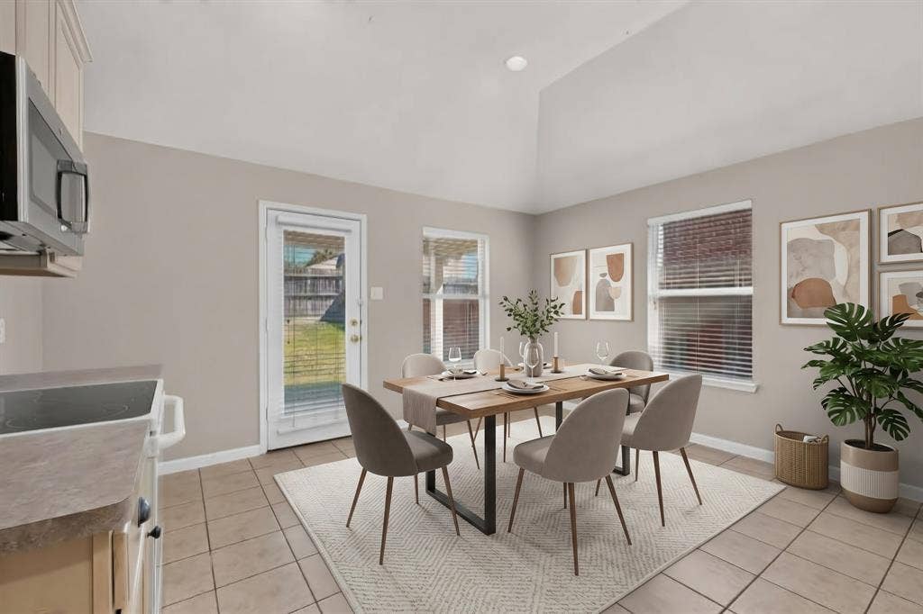 Vaulted ceiling, multiple windows, tile flooring, glass-paneled door, recessed lighting