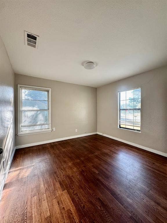 8018 S Reno Court, Dallas, TX 75217 Wood-finish flooring with neutral wall paint