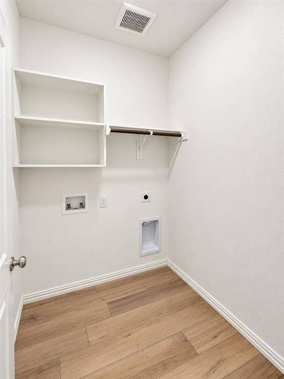 1605 River Crossing Drive, Anna, TX 75409 Built-in shelving, hanging rod, wood-finish flooring, and crisp white walls