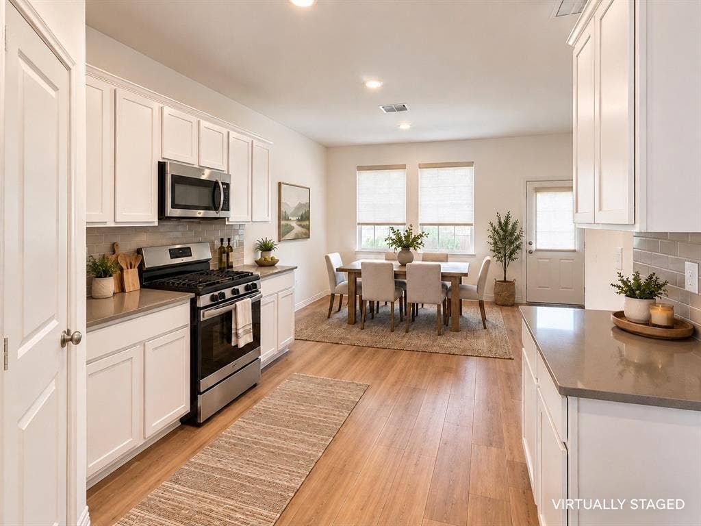1605 River Crossing Drive, Anna, TX 75409 White shaker cabinetry, stainless steel appliances, wood-finish flooring, and light countertops