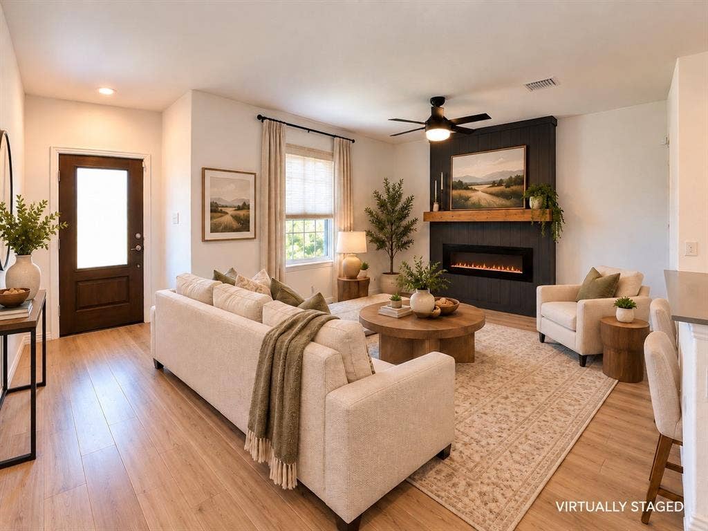 1605 River Crossing Drive, Anna, TX 75409 Living area featuring wood-finish flooring, an electric fireplace with a wood mantel, and a ceiling fan.