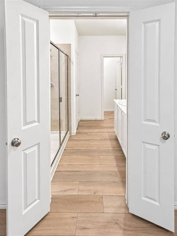 1605 River Crossing Drive, Anna, TX 75409 Wood-finish flooring throughout, bright white walls, and a glass-enclosed shower