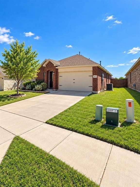 1605 River Crossing Drive, Anna, TX 75409 Brick exterior, attached garage, concrete driveway, concrete walkway, mature landscaping