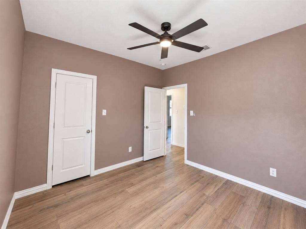 1605 River Crossing Drive, Anna, TX 75409 Wood-finish flooring, ceiling fan, white trim, and solid core doors