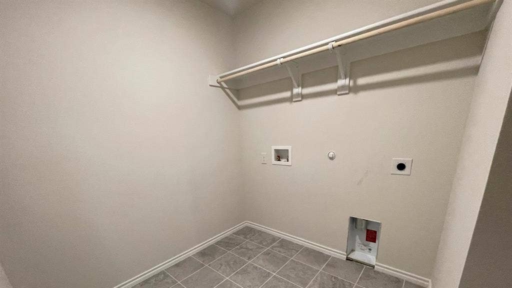 409 White Willow Drive, Nevada, TX 75173 Utility room with tile flooring, light-toned walls, and built-in shelving