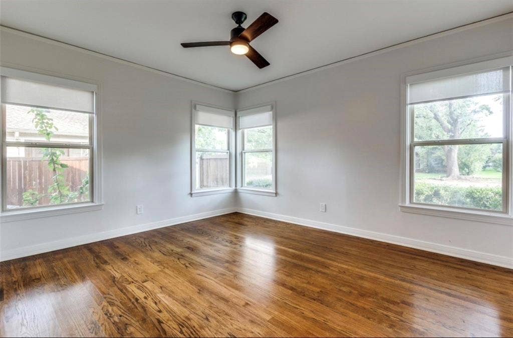 1323 Engle Avenue, Dallas, TX 75224 Wood-finish flooring, multiple windows, ceiling fan with integrated lighting, and crown molding