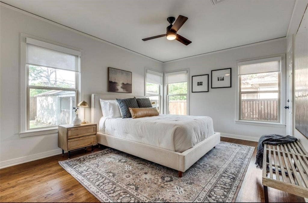 1323 Engle Avenue, Dallas, TX 75224 Wood-finish flooring, multiple windows with roller shades, ceiling fan with light, and light-toned wall paint