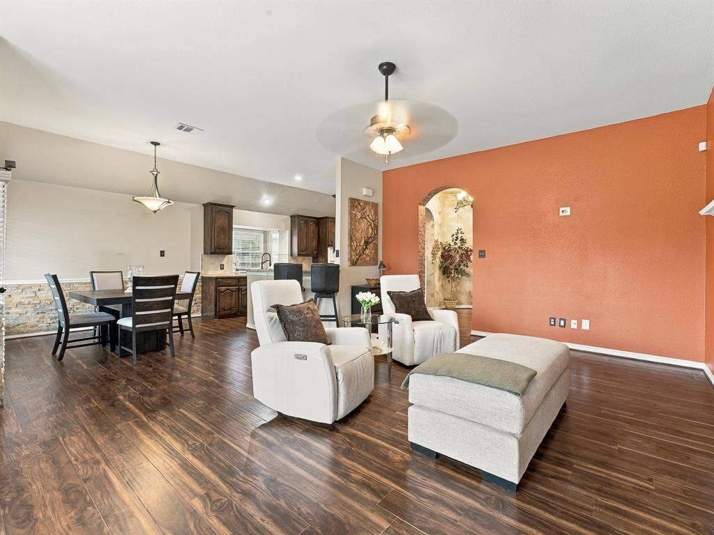 Wood-finish flooring throughout, with a recessed ceiling and a ceiling fan