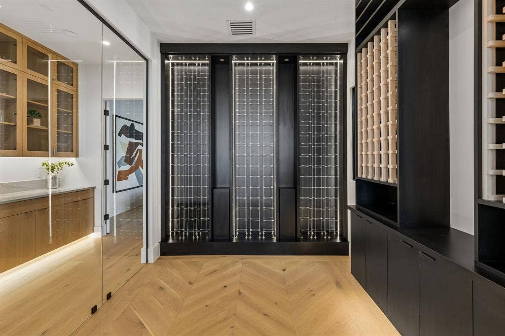 Beautiful wine cellar with glass walls, herringbone white oak floors