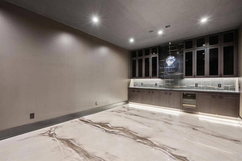 Basement Media room with ice machine, beverage refridgerator, built in shelving and cabinetry