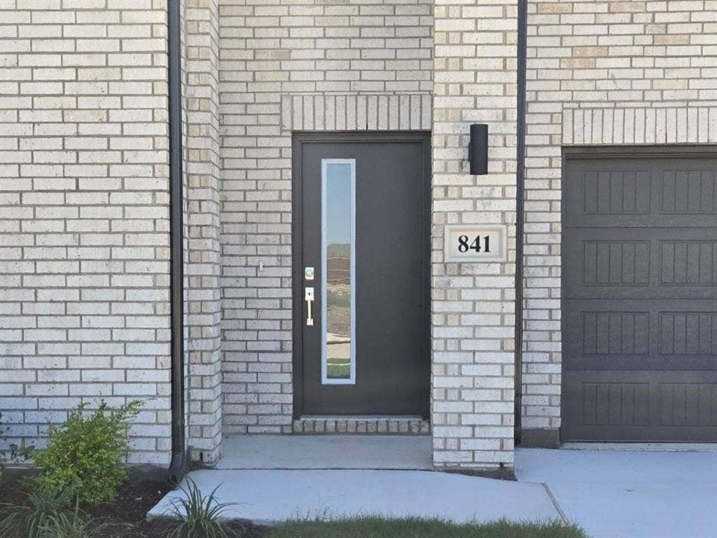 841 Rockcloud Drive, Fort Worth, TX 76052 Light-colored brick exterior with dark trim
