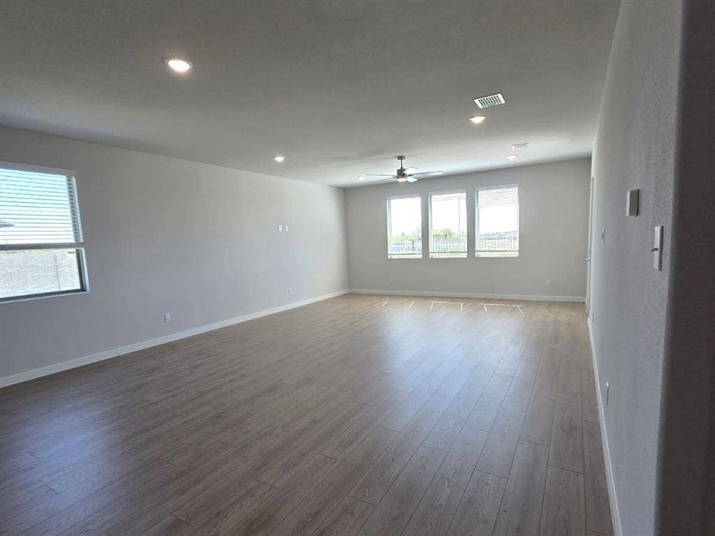 841 Rockcloud Drive, Fort Worth, TX 76052 Recessed lighting, wood-finish flooring, ceiling fan, multiple windows with blinds, and light-toned wall finishes