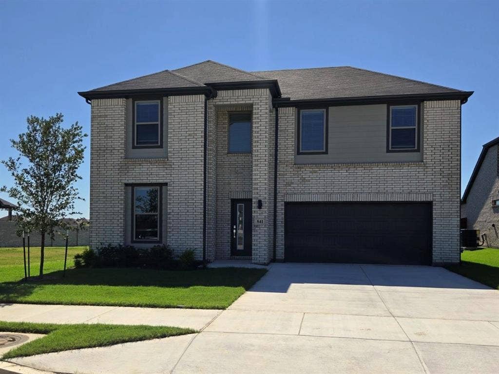 841 Rockcloud Drive, Fort Worth, TX 76052 Two-story brick facade, two-car garage, concrete driveway, front entry, landscaped front yard
