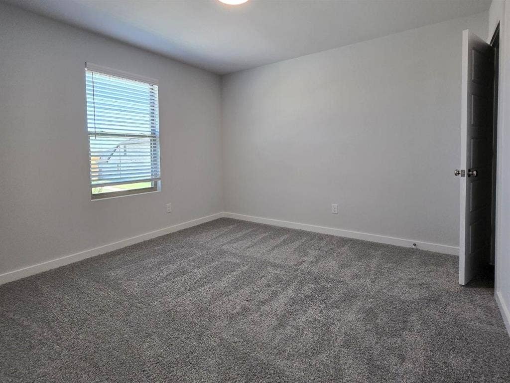 841 Rockcloud Drive, Fort Worth, TX 76052 Recessed lighting illuminates neutral-toned walls and plush carpet