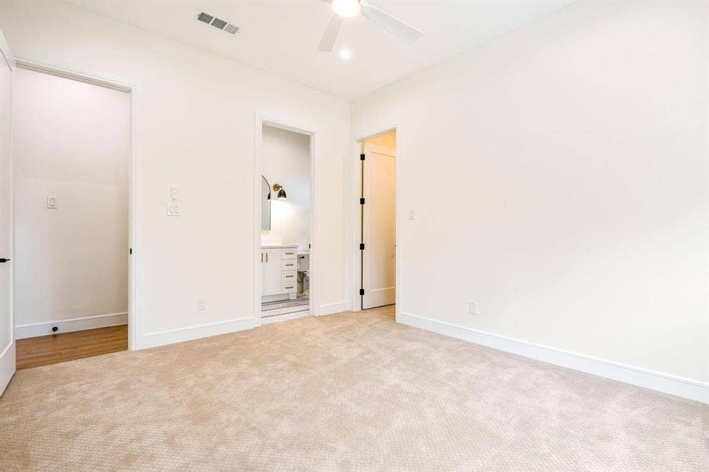 12007 Quincy Lane, Dallas, TX 75230 Plush carpet flooring in a neutral tone, ceiling fan with integrated lighting, and a white interior door