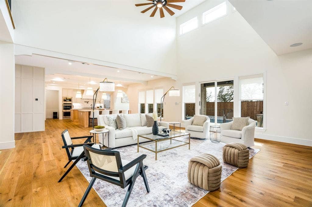 12007 Quincy Lane, Dallas, TX 75230 Vaulted ceiling with a ceiling fan, wood-finish flooring, sliding glass patio door, built-in kitchen appliances, and recessed lighting