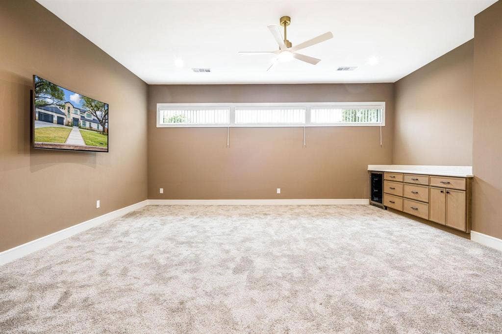 12007 Quincy Lane, Dallas, TX 75230 Recessed lighting, ceiling fan, built-in cabinetry, under-counter beverage cooler, and horizontal windows