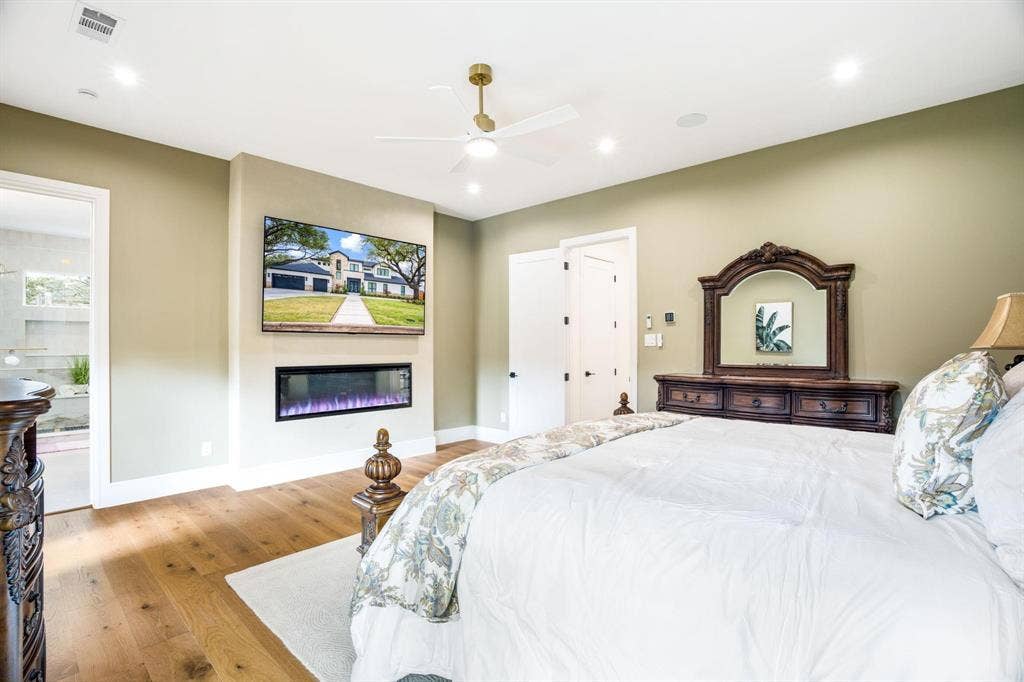 12007 Quincy Lane, Dallas, TX 75230 Wood-finish flooring, recessed lighting, and a ceiling fan